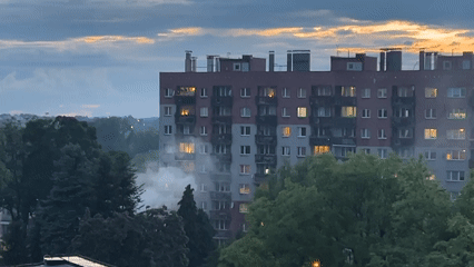 Apartment building smoke incident captured during sunset hours