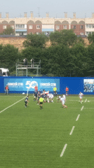 Rugby match underway in Krasnoyarsk with team banner on display