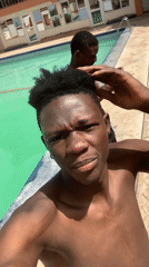 Young men enjoy sunny poolside leisure time in Jos