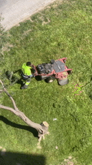 Groundskeeper operates lawn mower in Terrassa Spain Friday morning