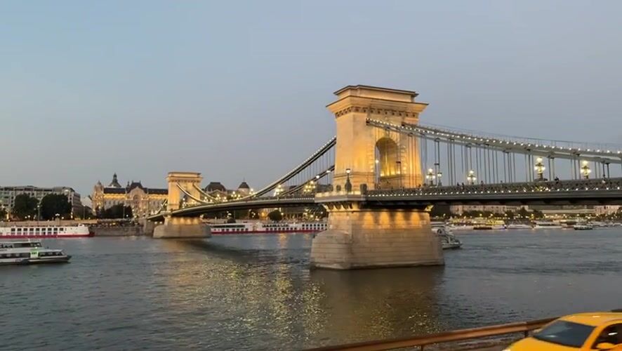 Budapest landmarks glow along the Danube at dusk