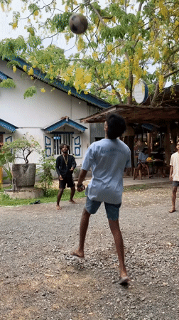 Young men play sepak takraw in Rumassala gravel court