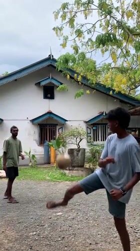 Young men play sepak takraw in Rumassala gravel court