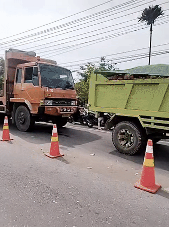 Orange utility truck with crane spotted on Lhokseumawe road