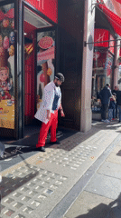 Street performer entertains outside London's Harrods toy store
