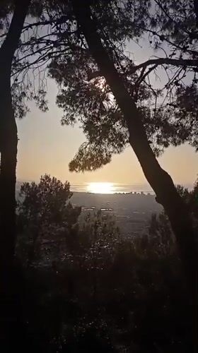 Morning Barcelona cityscape viewed from hillside with cat keychain