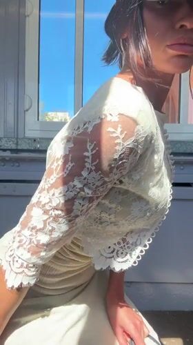 Woman tries on vintage clothing at Tunbridge Wells thrift store