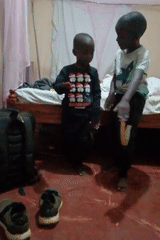 Two barefoot boys observed in indoor residential setting