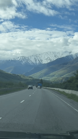 Highway traffic recorded near Chmi, Russia with mountain backdrop