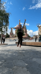 Tourist dances at Red Square as street musicians perform nearby