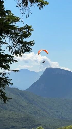Summer morning in Molveno: paragliding, chairlifts, and Dolomite views