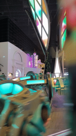 Neon-lit indoor amusement rides at a Doha entertainment venue