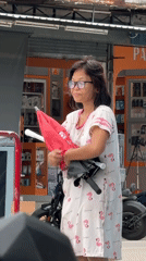 Woman in flamingo dress observed on Koh Phangan streets