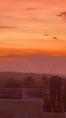 Mũi Né sunset fades from orange to purple over wind turbines