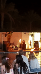 Poolside fire performance at an Egyptian resort at night