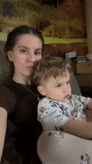 Mother and child share quiet moments on couch in Klin