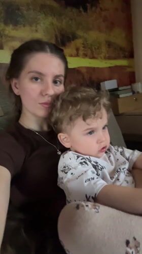 Mother and child share quiet moments on couch in Klin