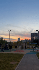 Father and child enjoy evening playground time in Moscow