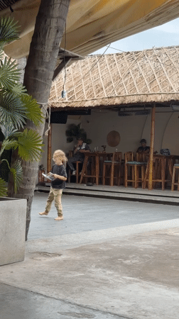 Morning moments captured in Vietnamese residential area with selfies, scooter