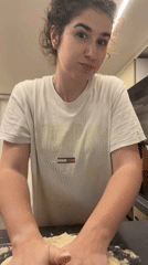 Woman kneads dough in Sofia kitchen