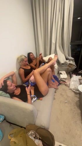 Three women relax in messy post-party room in Thailand