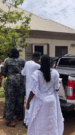 Community gathering around white van in Bukuru, Nigeria