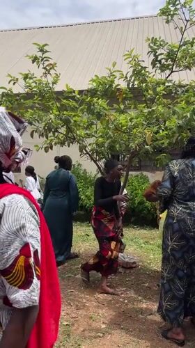 Community gathering around white van in Bukuru, Nigeria