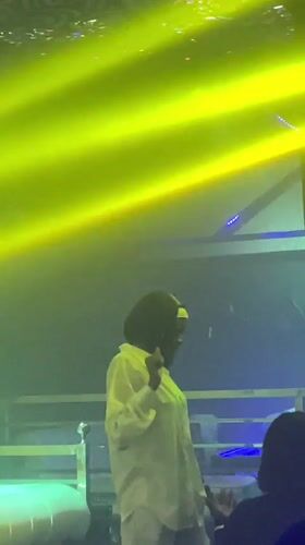 Nigerian nightclub scene with DJ, dancers, and illuminated props