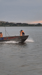 Golden hour at a Kokshetau lake — boats, shoreline play, and dancing