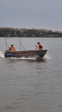 Golden hour at a Kokshetau lake — boats, shoreline play, and dancing
