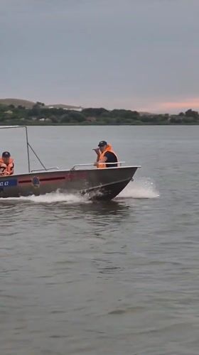 Golden hour at a Kokshetau lake — boats, shoreline play, and dancing