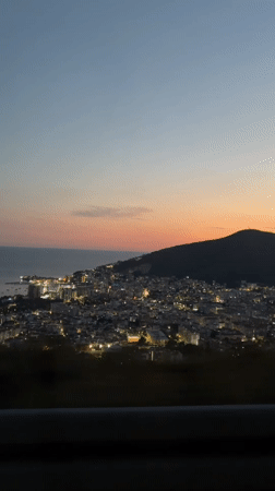 Dusk hits Budva from above and inside a car