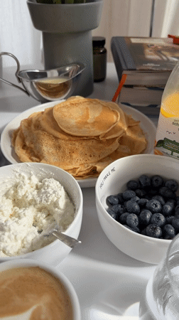 Pancakes, crepes, and fruit at a morning breakfast table in Gangloff