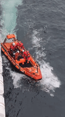 Orange rescue boat 87 operates in choppy ocean waters