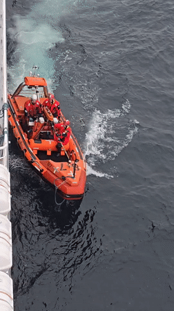 Orange rescue boat 87 operates in choppy ocean waters
