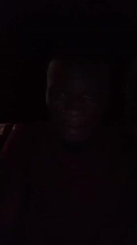 The video is dark and grainy. It appears to be taken at night, possibly with a cell phone camera. 

At 00:00, a person's face is visible, illuminated by a dim light. The person is wearing a dark shirt. 

From 00:01 to 00:04, the video shows a blurred, dark environment with occasional streaks of light. It's difficult to discern any specific objects or actions.