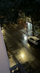 Rainy street scene captured from balcony in Buenos Aires