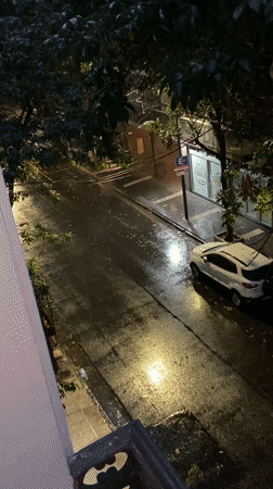 Rainy street scene captured from balcony in Buenos Aires