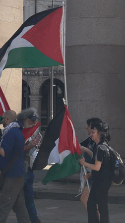 Pro-Palestinian demonstration held in Milan plaza, multiple flags displayed