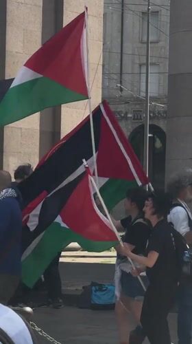Pro-Palestinian demonstration held in Milan plaza, multiple flags displayed