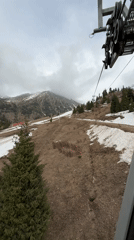 Ski lift ride filmed on patchy snow slopes near Almaty