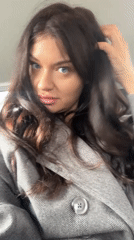 Woman in grey coat filmed in close-up in Moscow