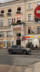 Moscow street scene documented showing multi-story building, busy traffic