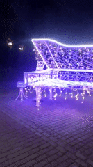 Decorated street piano and evening walkway life in Navapolatsk