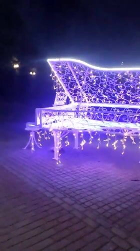 Decorated street piano and evening walkway life in Navapolatsk