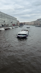 Tourist documents spring morning walk through historic Saint Petersburg