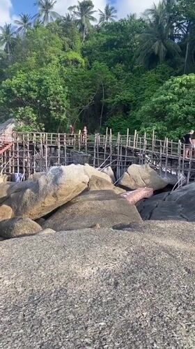 Tourists visit scenic rock formations at Ban Tai beach Thailand