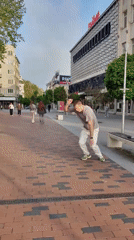 Person performs backflip off bench on brick walkway