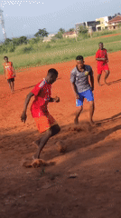 Barefoot football match played on dirt field in Nsugbe