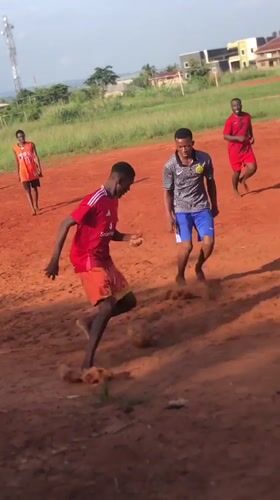 Barefoot football match played on dirt field in Nsugbe